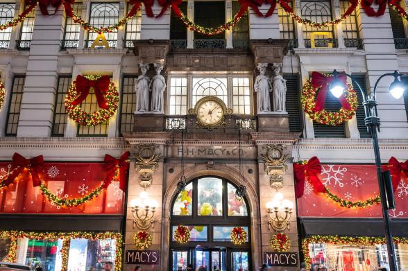 Macy's Herald Square Macy's storefront adorned with holiday lights and decorations at night