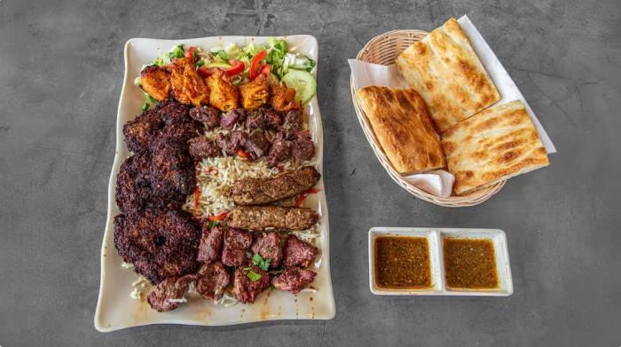 A picture of the family combo at Afghan Kebab House, which includes a mix of kebabs, rice, salad, naan and chutney.