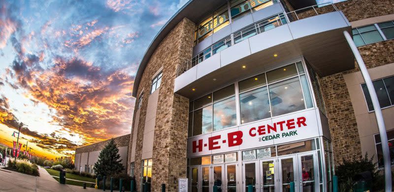 exterior fish eye shot of the heb center and a sunset in the background