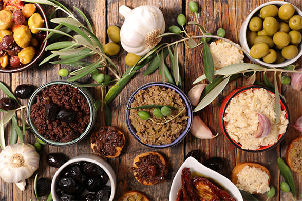 Bowls of Mediterranean food on a wooden table