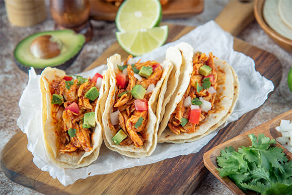 Three shrimp tacos in flour tortillas