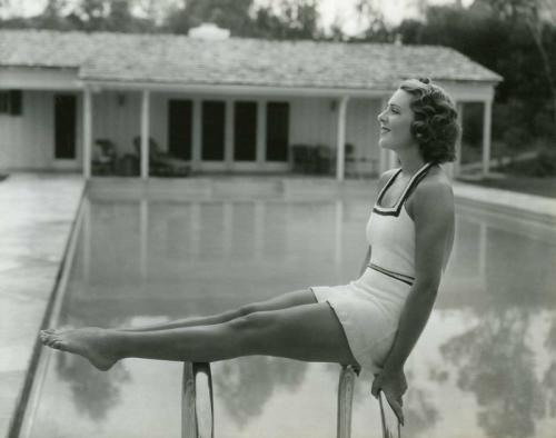 A 1930s picture of Ruby Keeler poolside at a home.