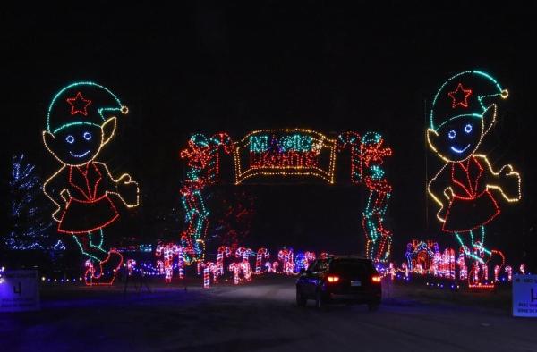 Image of holiday lights lit up that reads "Magic of Lights".