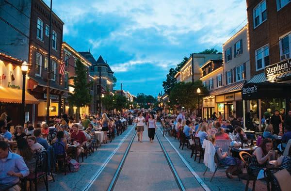 people dining on main street by restaurants
