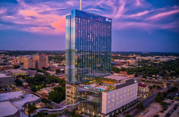 Exterior at sunset with skybridge and rooftop pool at the Fairmont hotel in Austin Texas