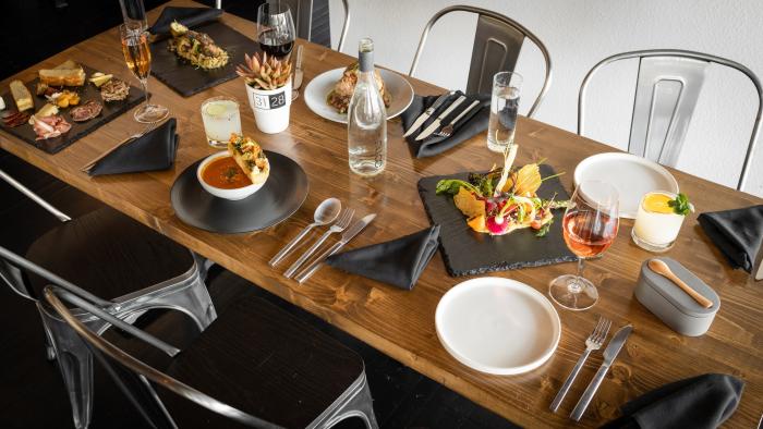 A spread of food and beverages on a table at 3128 Social House.