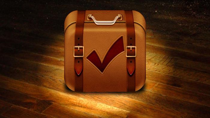 An image of a Travel App shows a suitcase with a check mark on it