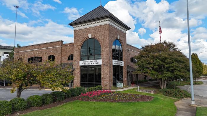 Huntsville Convention and Visitors Bureau building with landscaped grounds and blue sky in Alabama