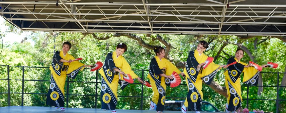 five women perform in traditional dress at CelebrAsia festival hosted by Asian American Resource Center in Austin Texas