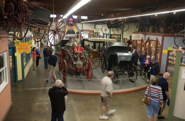 Mackinac Island visitors explore the history of horse-drawn transportation at the Surrey Hill Carriage Museum.