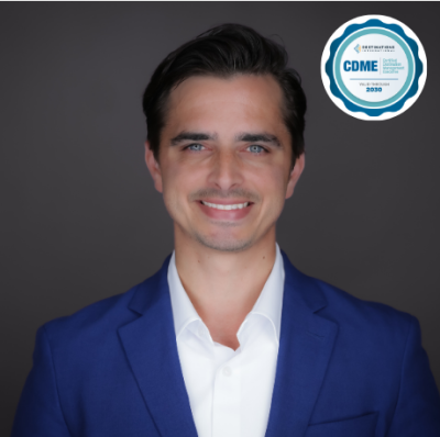 Headshot of man in royal blue suit with CDME certification badge