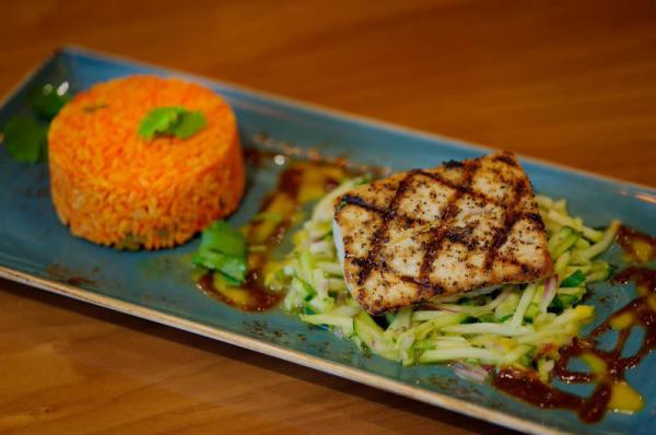 Grilled fish with a side of rice at Torre Restaurant.