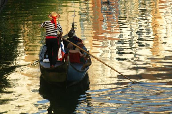 A gondolier guides his guests along the Mandalay Canal in Irving, TX