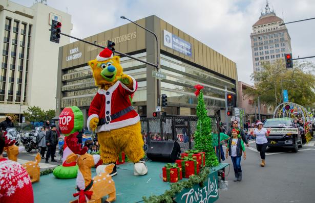 individuals watching Christmas parade on fulton street