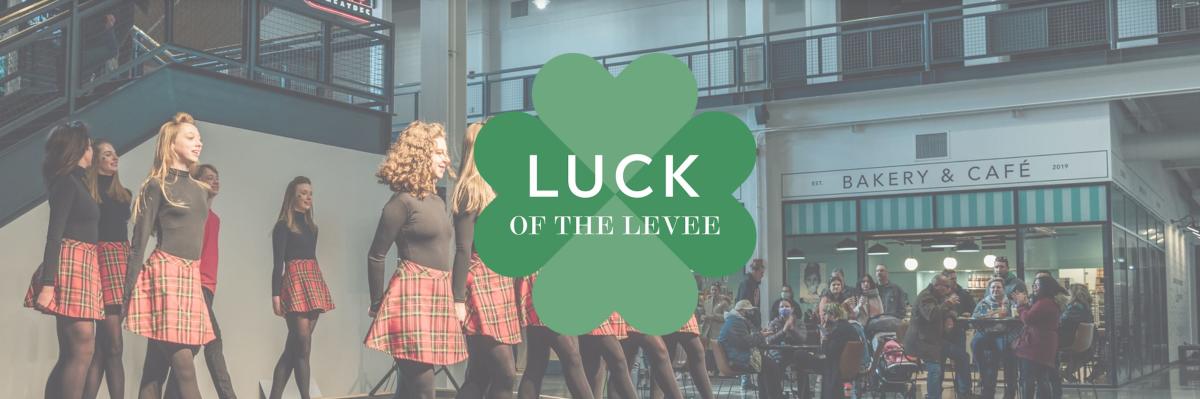 Image of inside Newport on the Levee with Irish Dancers on stage and a shamrock dead center that say's "Luck on the Levee".