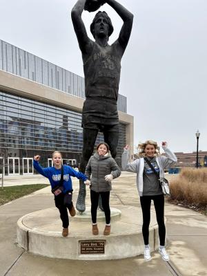 Larry Legend Statue with people jumping