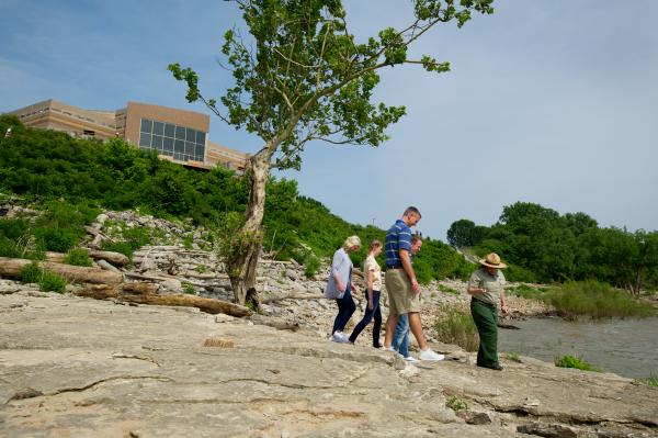 Family walking with the park ranger at Falls of the Ohio