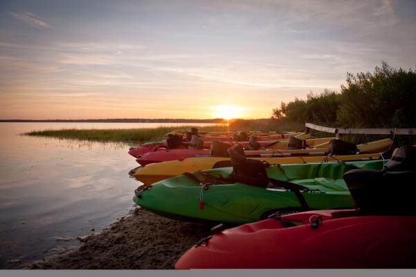 Kayaks line the shore at Happy Ours Kayak & Bike Outpost on Cape San Blas.