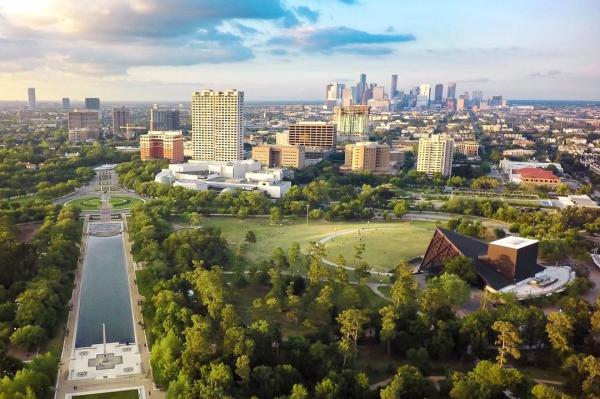 An overhead capture of Hermann Park with Houston's downtown skyline in the distance.