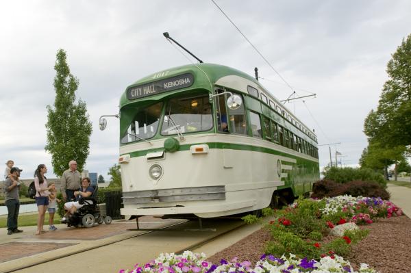 Streetcar with multi-generational family, kids, wheelchair, flowers