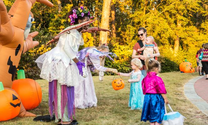 Fairies at Spooky Springs passing out candy to children dressed as Elsa and Anna
