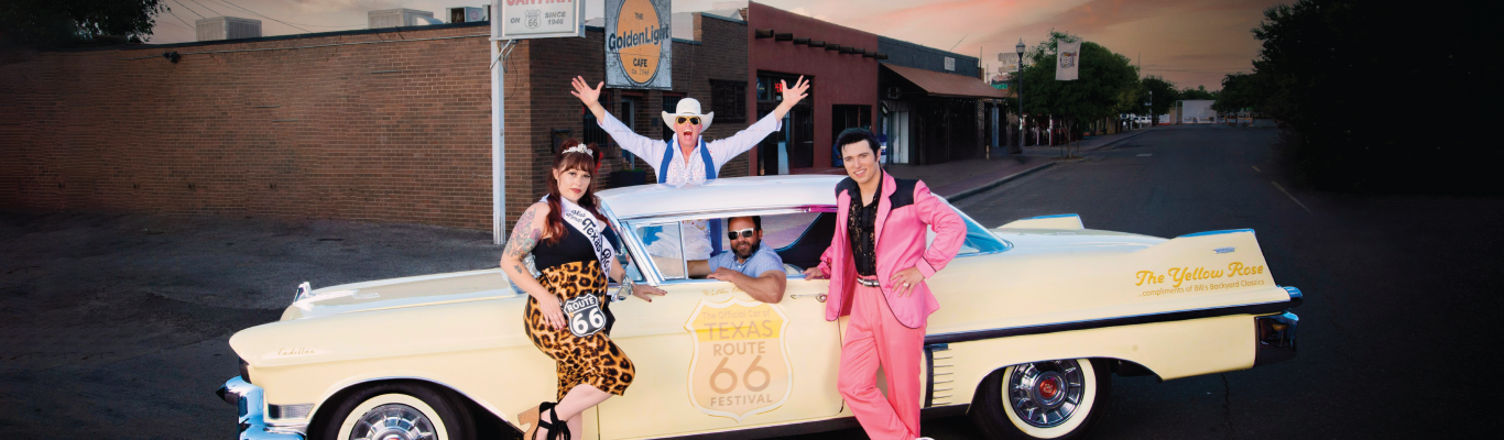 two elvis impersonaters and a pinup woman in a classic white car with Amarillo's mayor driving looking excited
