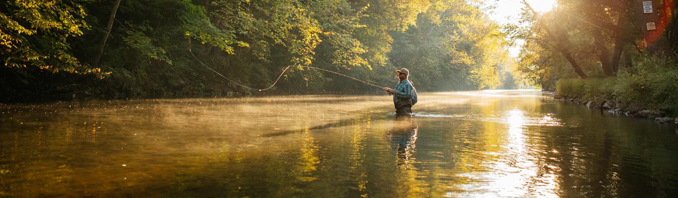 Man wading in the Yellow Breeches Creek fishing