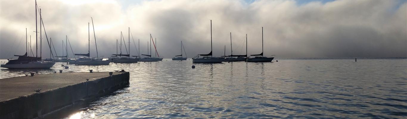 Lakeview with sailboats and mist rising in the morning