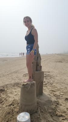Women standing on sandcastle