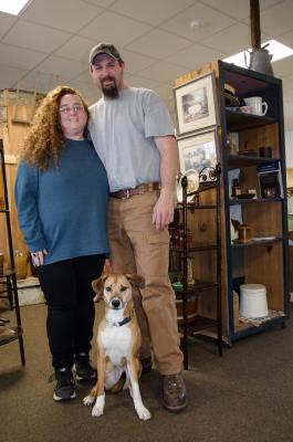 Owners Denise and Josh (with Jake) stand in the newly reopened Barn Fresh Vintage Market.