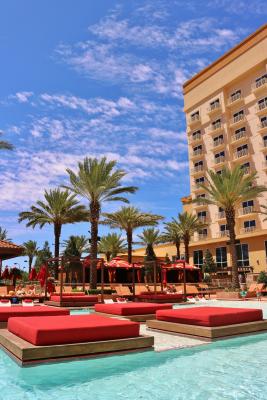 palm trees, lounging area, cabanas, and exterior of Golden Nugget