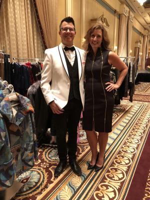 Danny Reynolds and his wife stand in front of clothing racks at Stephenson's of Elkhart