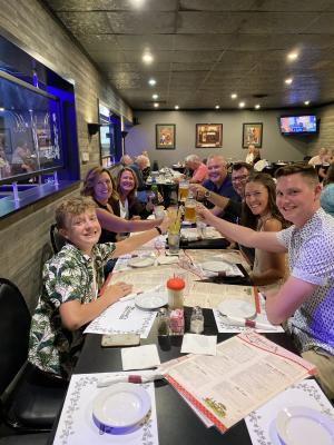 A group at a long table raises a toast at Michael's Restaurant in Elkhart, Indiana