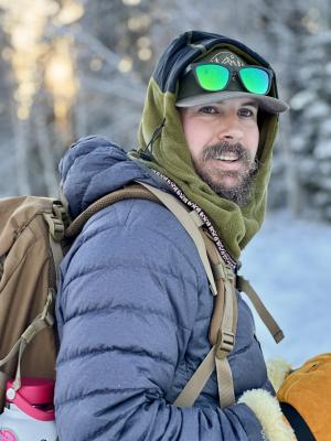Man wearing winter clothing on a beautiful winter day in Fairbanks, Alaska.