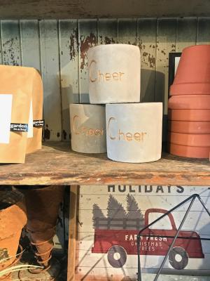Planters labeled "Cheers" on a shelf