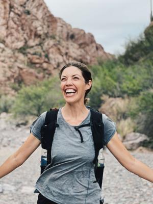 Rocky Mountain Hiking Company - Girl around mountains with backpack smiling