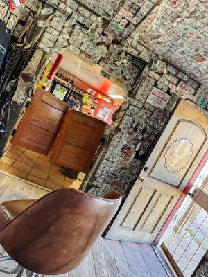 Dollar bills signed by visitors cover the walls inside El Cuerno Cantina in Cebolla.