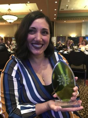 Marketing director Megan Buchbinder holding award.