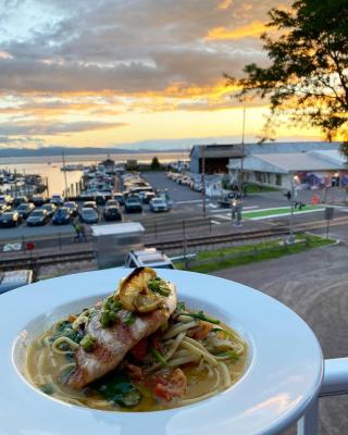 seafood pasta in front of a sunset over Lake Champlain