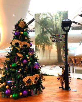 A close up of a christmas tree with a mask on it. Mardi gras tree