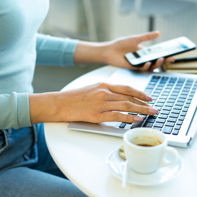 woman working on a laptop and phone