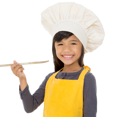 Girl wears chef's hat and apron holding wooden spoon