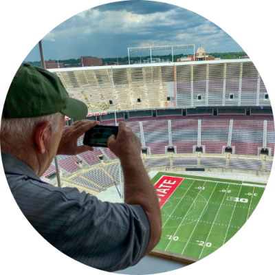 Man taking photo of Ohio State stadium field from press box