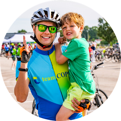 Bike rider and son posing for photo