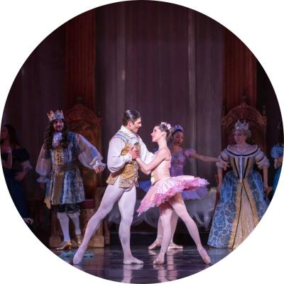 Woman and man on stage in ballet tights and costumes