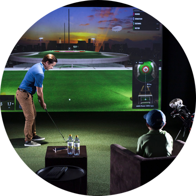 Father swinging club in golf simulator
