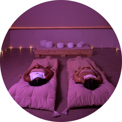 Two people laying in Paloma spa room lit by candles