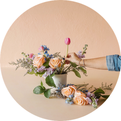 Hand putting flowers in a vase