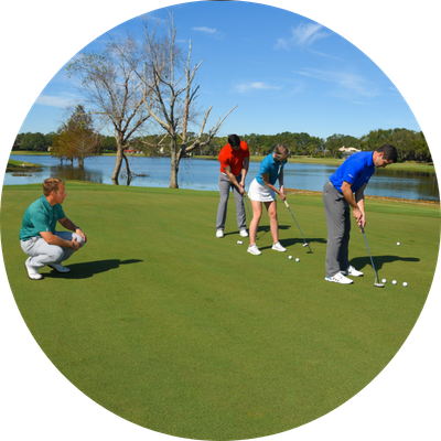 Three people putting golf balls