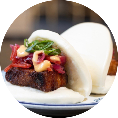 Steamed buns with tofu, achara slaw, spicy mayo and scallions